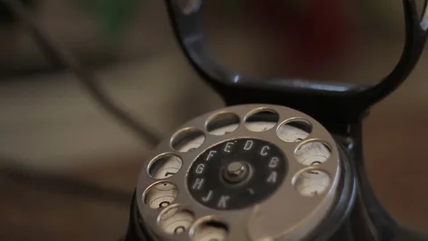 Closeup of an old black disk phone stands on an antique desk Stock Footage 82182603
