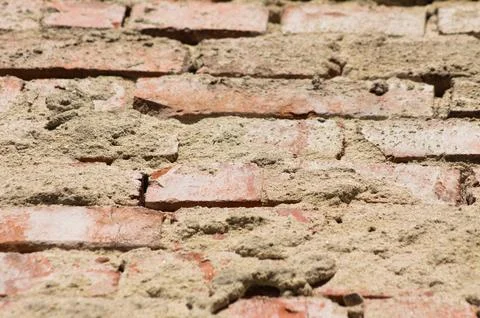 Closeup of old brick wall with selective focus on foreground Foto stock