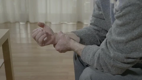 Closeup of old man with arthritis touching his painful wrist having rheumatis Video stock 88401964