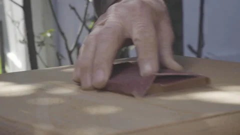Closeup of old man hand sanding old wooden furniture Stock Footage 140293210