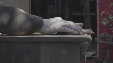 Closeup of old man hand sanding old wooden furniture Video stock 140294253