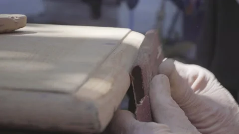 Closeup of old man hand sanding old wooden furniture Stock Footage 140296026