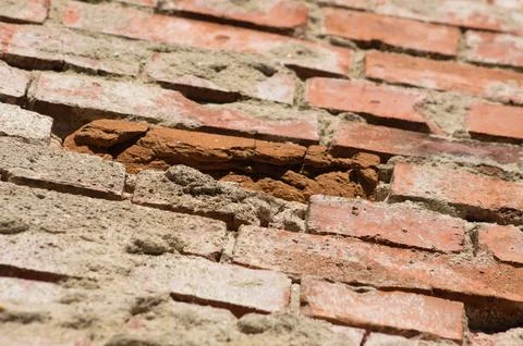 Closeup of old red brick wall with selective focus on foreground Foto stock