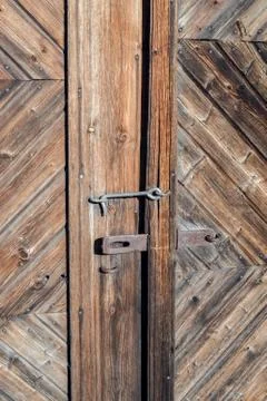 Closeup of an old rusted lock on a rustic rural door with decorative natural Stock Photos