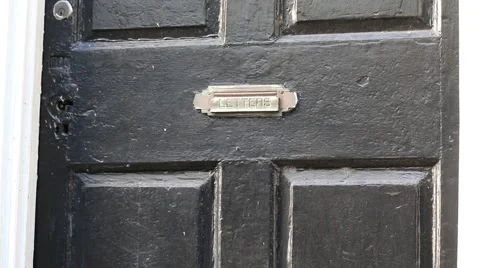 Closeup of old rustic black door with name Stock Footage 45632632