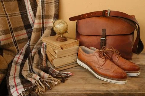 Closeup old things, stack of vintage books, globe, shoes, leather military .. 스톡 사진