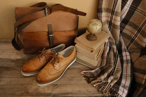 Closeup old things, stack of vintage books, globe, shoes, leather military .. 스톡 사진