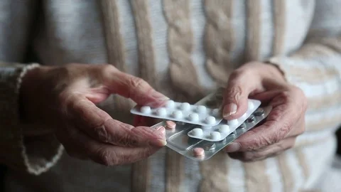 Closeup of old woman’s hands holding packages of medication Stock Footage 69903007