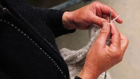 Closeup of old womans hands knitting Stock Footage 79337546