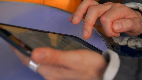 Closeup of a Older Gentleman's Hands as He Types On His Handheld Tablet Screen. Stock Footage 120346445