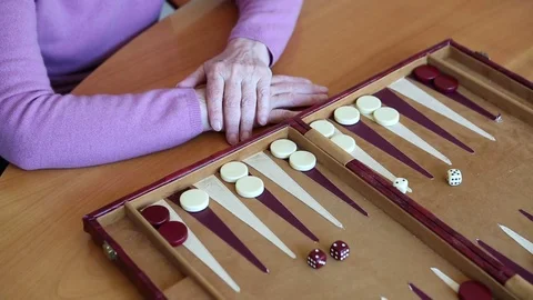 Closeup of older woman playing backgammon Stock Footage 71679585