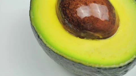 Closeup of one half cut avocado is rotating on the turntabl Stock Footage 220304358