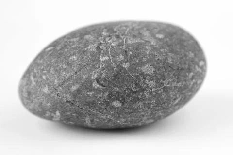 Closeup of one rock on plain background Stock Photos