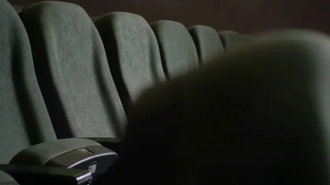 Closeup one Row of Empty Gray Chair in Dark Cinema Hall Stock Footage