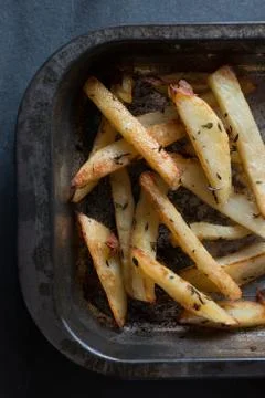 Closeup of One Side of Baking Tray Containing Cooked Chips Stock Photos