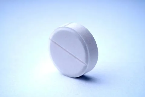Closeup of one tablet on a white background with texture. Stock Photos