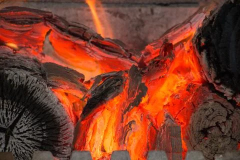 Closeup of an open fireplace inside the house Stock Photos