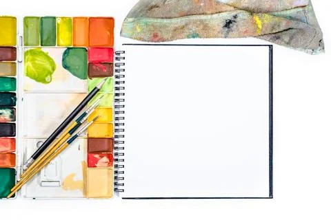 Closeup open note book with tray colors on background Stock Photos