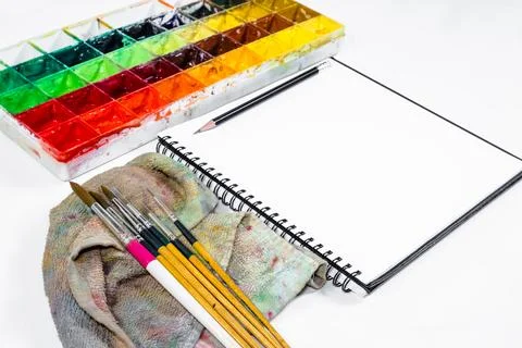 Closeup open note book with tray colors on background Stock Photos