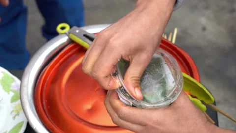 Closeup opening a plastic container of chimichurri with the hands and serving it Video stock 160089362