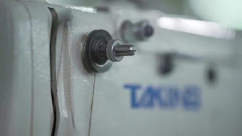 Closeup Of A Operating Sewing Machine With Cotton In A Sweat Shop Stock Footage 143266597