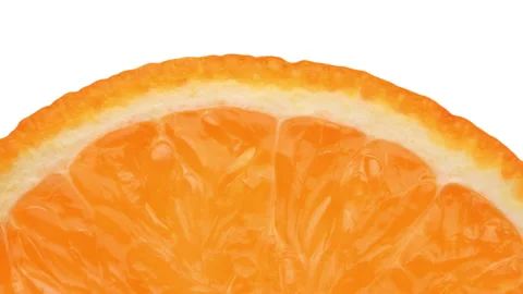 Closeup of orange fruit slice rotating. White background. Stock Footage 158914582