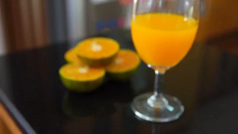 Closeup orange juice on table in kitchen Video stock 91936439