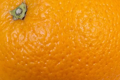 Closeup orange peel texture highlighting pores and gloss, vibrant citrus surf Stock Photos