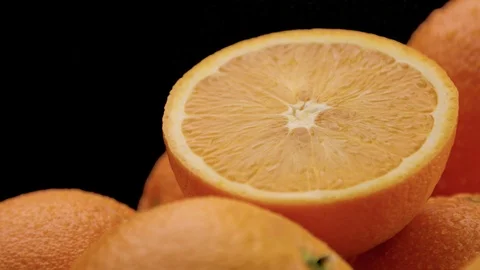 Closeup of oranges on black background Stock Footage 86013680