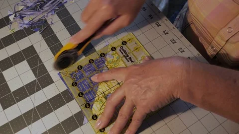 Closeup Overhead view Trimming Quilt Squares with Rotary Trimmer Stock Footage 79776255