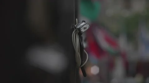 Closeup of Padlock with Flowing Flags Behind Stock Footage 130484855