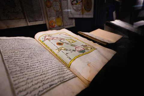 Closeup of a page from a transcript with beautifully drawn calligraphy and drawi Stock Photos