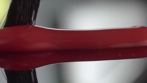 Closeup of Paintbrush Mixing Red Acrylic Paint With Smooth Liquid Texture and Stock Footage 340802404