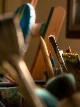 Closeup of Painting Tools Including Brushes Palette Knife and Canvas 스톡 사진