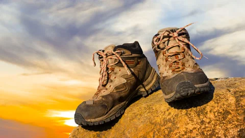 Closeup pair of touristic boot on sea coast at the sunset Video stock 201129498
