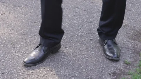 Closeup - Pan up from feet to a man dancing in the park outside - shot on RED Stock Footage 124719097