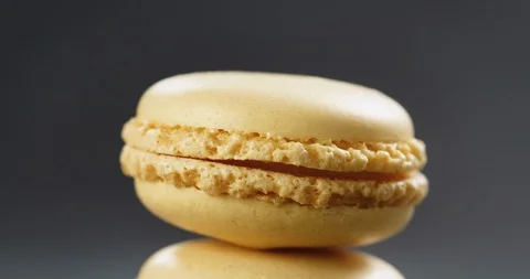 Closeup pan of lemon yellow macarons stacked on slate board Video stock 99533787