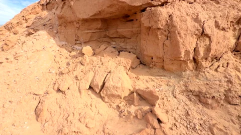 Closeup pan shot of eroded sandy sediment along dry riverbed in arid desert Vídeo Stock 327467859