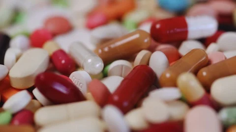 Closeup pan shot of many different medication pills Stock Footage 95913317