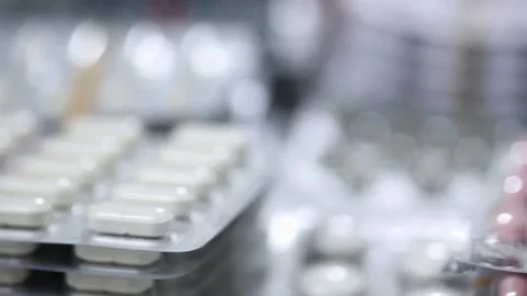 Closeup pan shot over stacks of blisters of medication Stock Footage 154309030