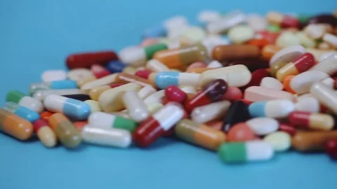 Closeup pan shot of pile of medication pills Stock Footage 95480176