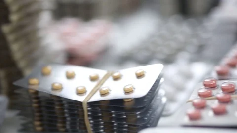 Closeup pan shot of stacks of different pills in their blisters Stock Footage 123479172