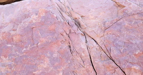 Closeup pan of smooth with erosion layers and scales multi color pink rock 4k Stock Footage 316976834