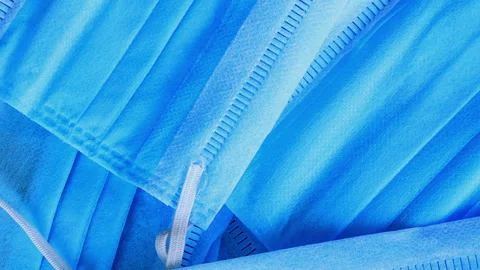 Closeup Pan Stack of Blue Medical Masks or Paper Masks. Top Down Video. Stock Footage 131718315