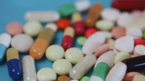 Closeup pan view of many different colorful pills Stock Footage 95912802