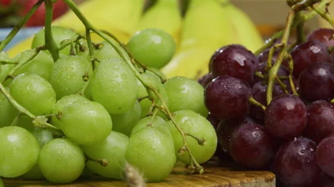 Closeup, panning shot across fresh green and red grapes Stock Footage 341199072