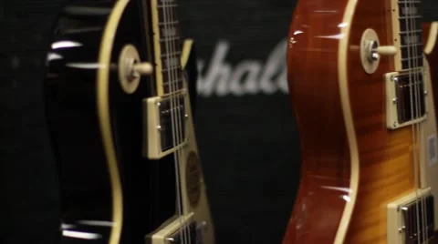 Closeup Panning Shot of Guitars on Wall in Music Store Stock Footage 49120404