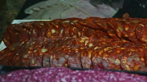Closeup panorama at assortment of different types of salami slices at food court Stock Footage 142543037