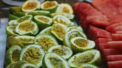 Closeup panorama down at assortment of sliced tropical fruits at food court Stock Footage 140221385