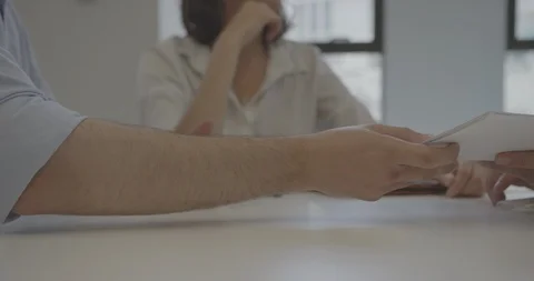Closeup of papers exchanging hands in business deal Stock Footage 93200055